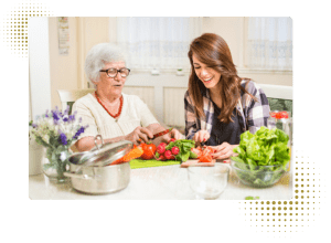 Two ladies cooking a meal.