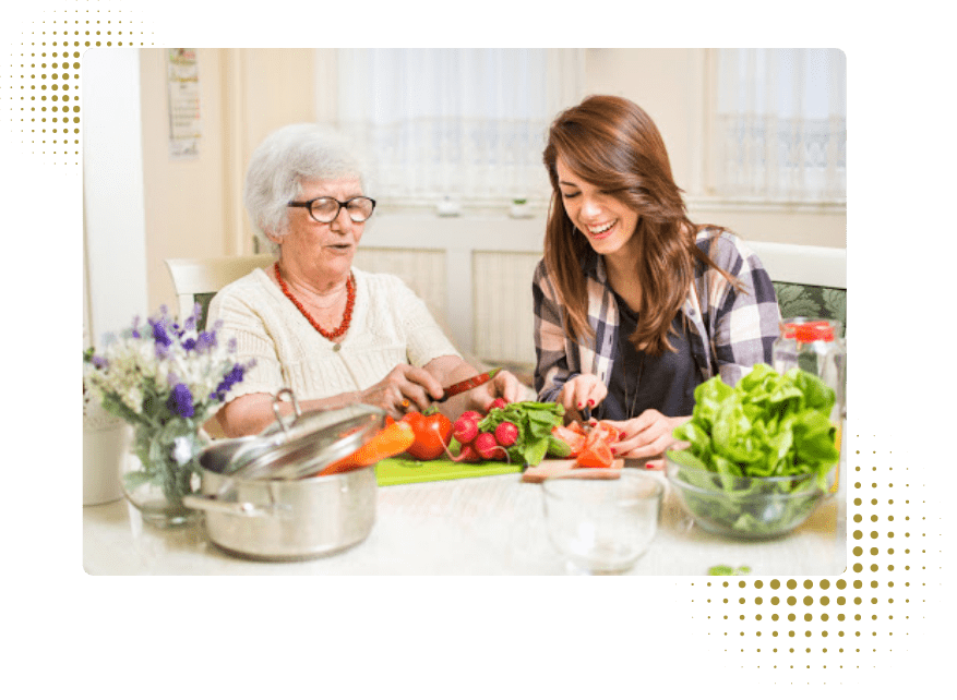 Two ladies cooking a meal.