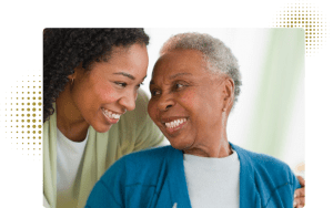 two ladies smiling at each other.