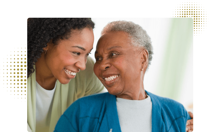 two ladies smiling at each other.